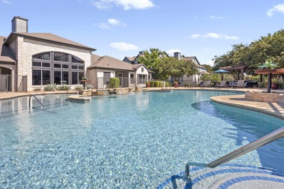 Resort-style pool and clubhouse at Camden Amber Oaks apartments in Austin, TX