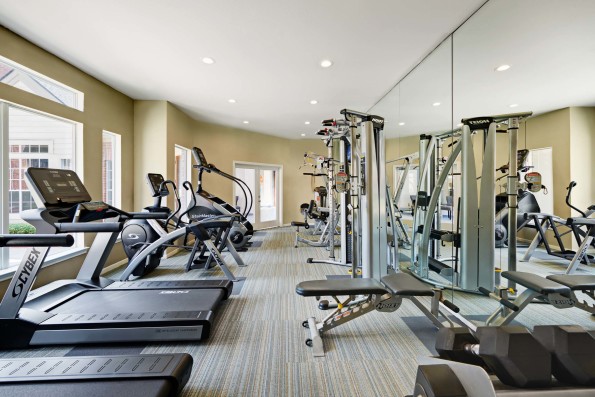 Fitness center with cardio equipment and free weights at Camden Stonebridge Apartments in Houston, TX
