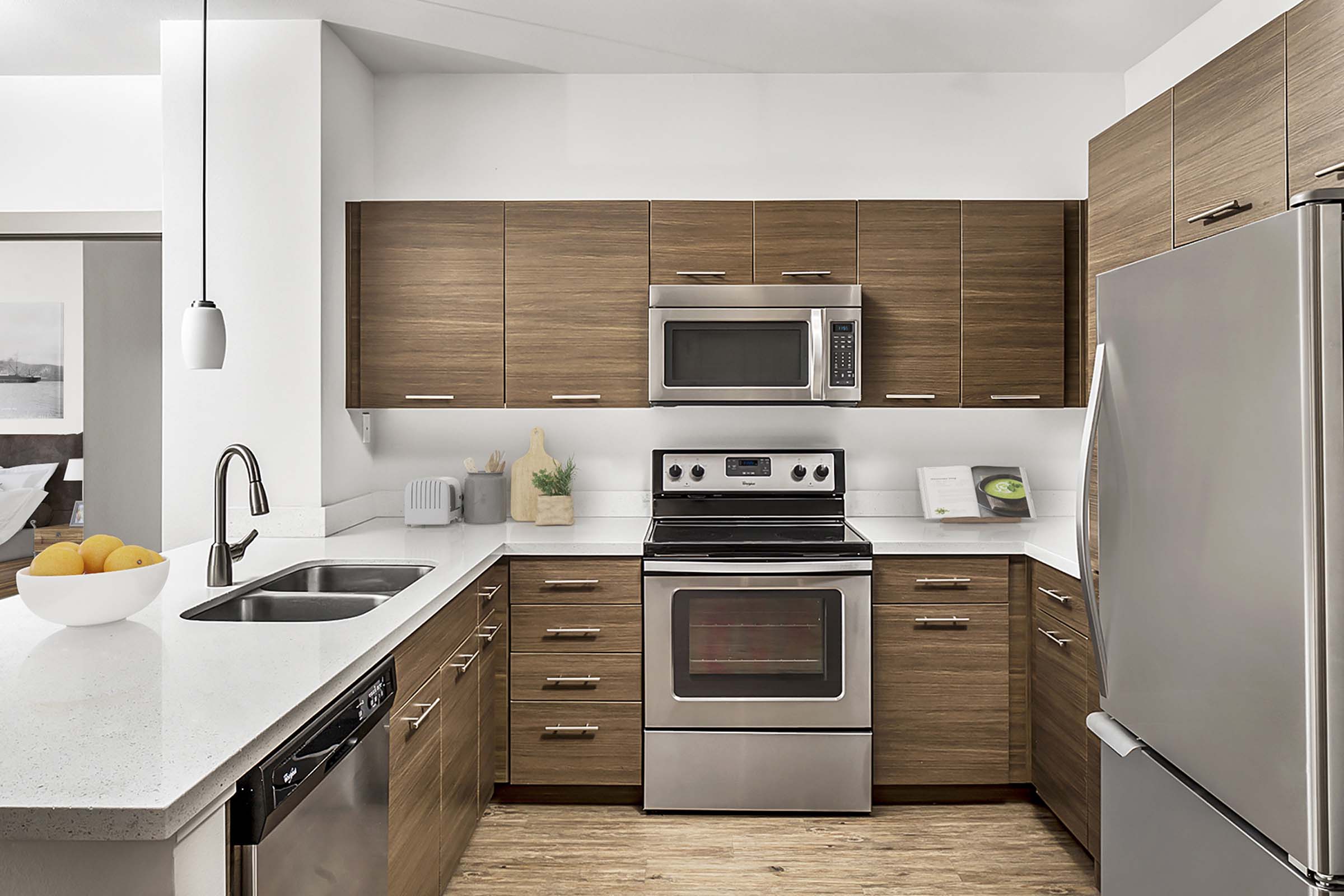 Kitchen with quartz countertops stainless steel appliances and glass cooktop