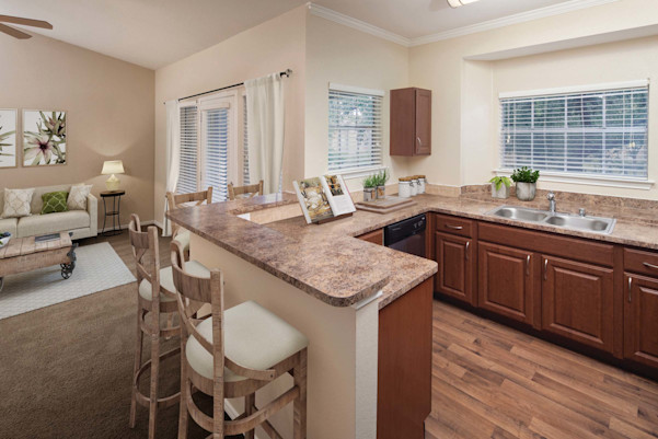 Kitchen with window and living room with carpet and balcony
