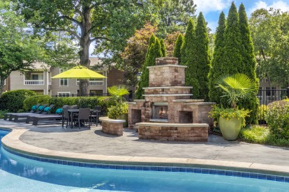 Outdoor fireplace next to saltwater pool at Camden Fairview in Charlotte North Carolina