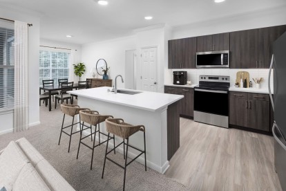 Spacious kitchen with island and dining area at Camden Panther Creek apartments in Frisco, TX