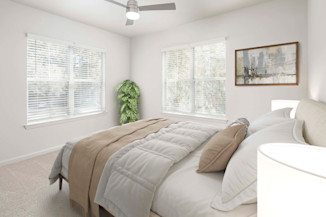 Bedroom with natural lighting and lighted ceiling fan at Camden Westwood in Morrisville, NC