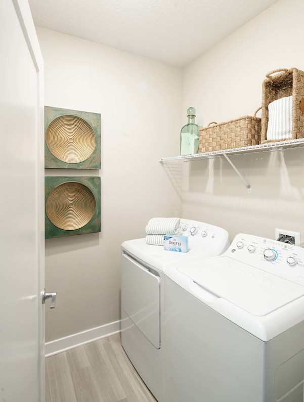 Laundry room with full-size washer and dryer at Camden Clearwater apartments in Clearwater, FL