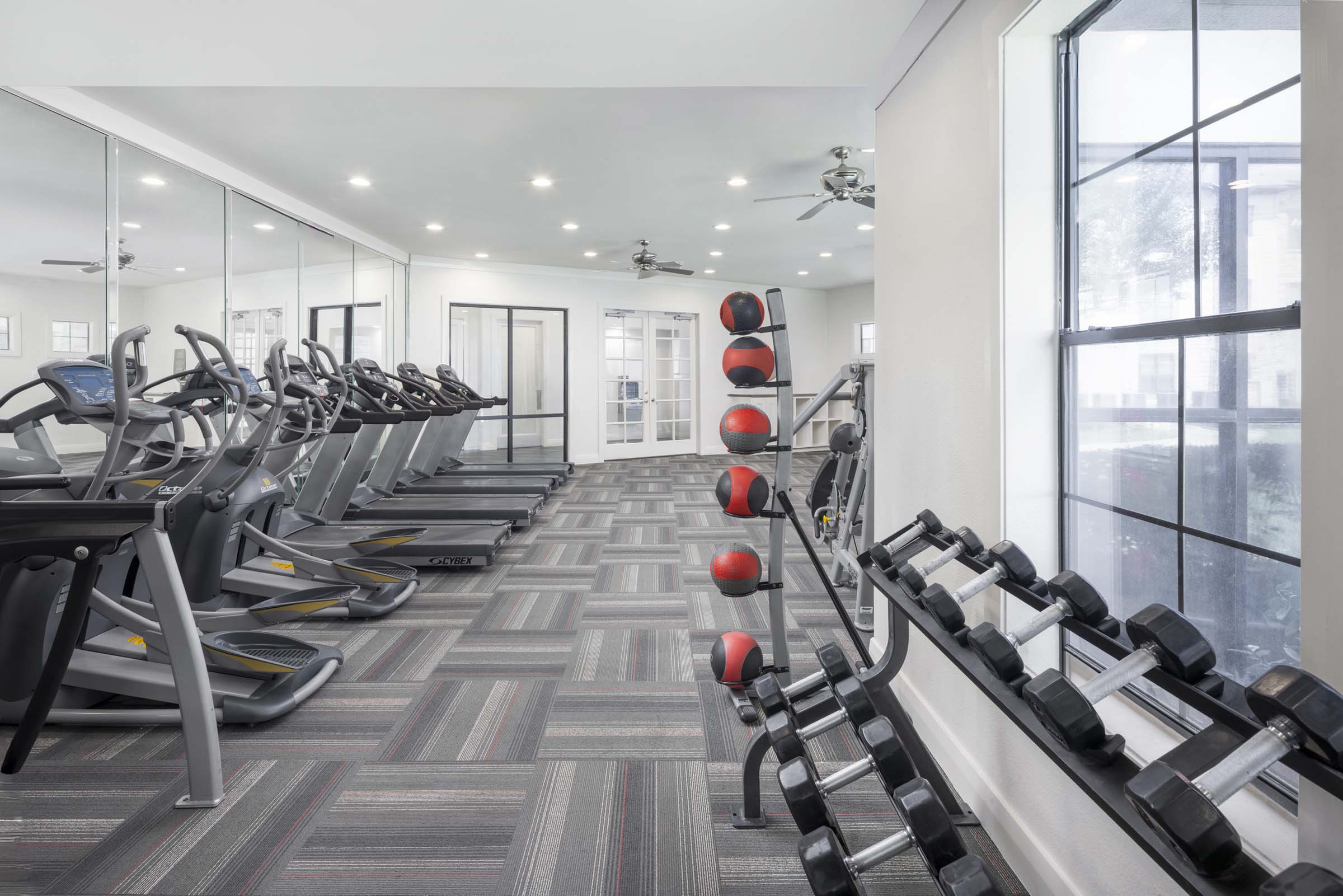 Fitness center cardio and free weights at Camden Yorktown apartments in Houston, TX