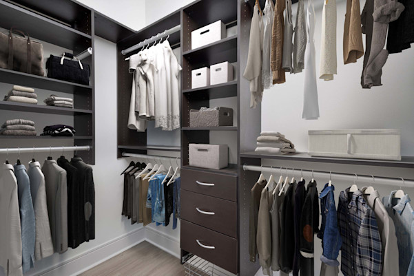 Townhome walk-in closet with customizable, built-in wood shelves and drawers at Camden Belmont apartments in Dallas, TX