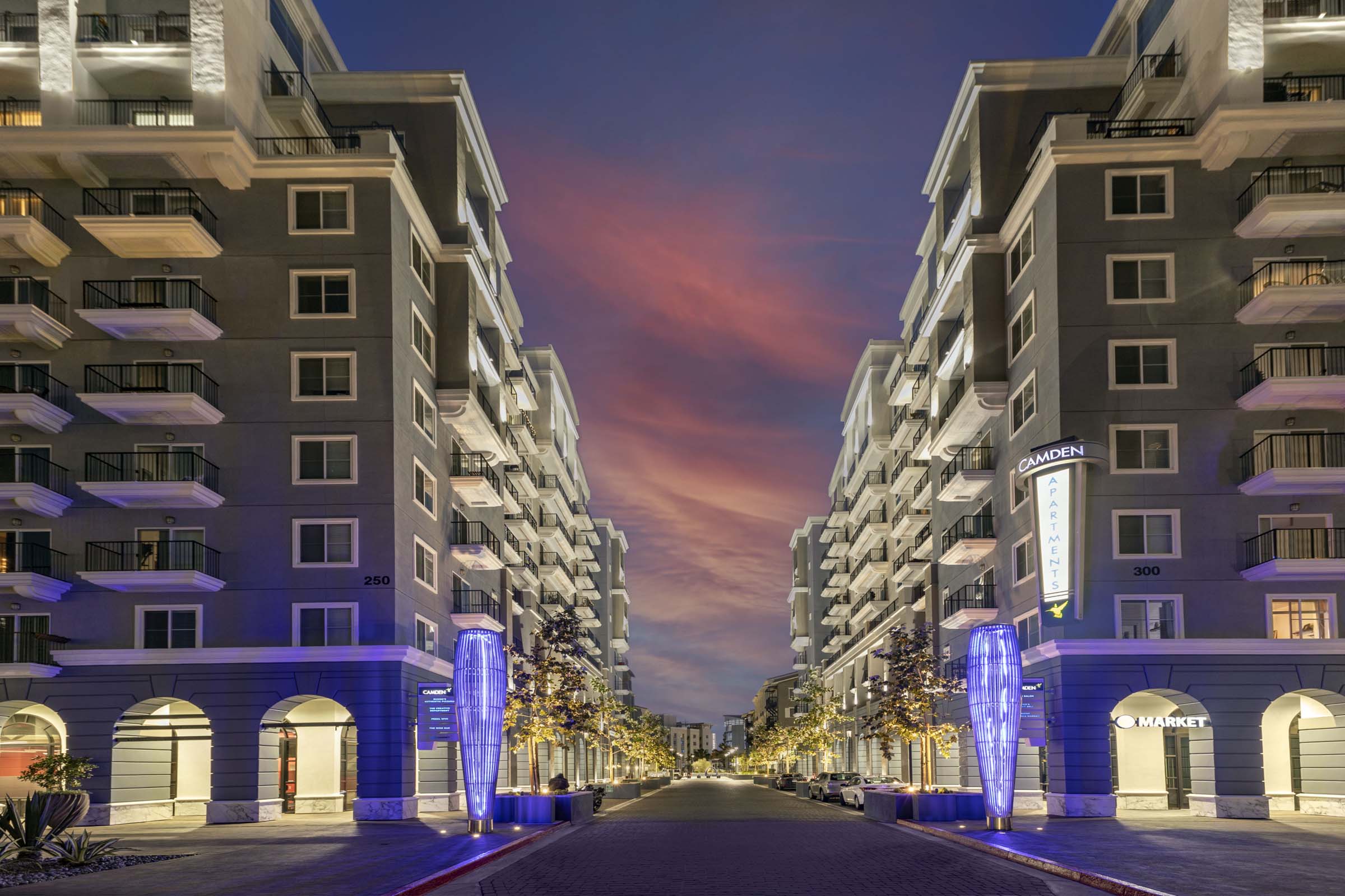 Camden Harbor View Apartments at dusk with retail spaces below homes