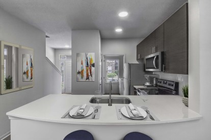 Townhome floor plan kitchen with quartz countertops stainless steel appliances and undermount sink