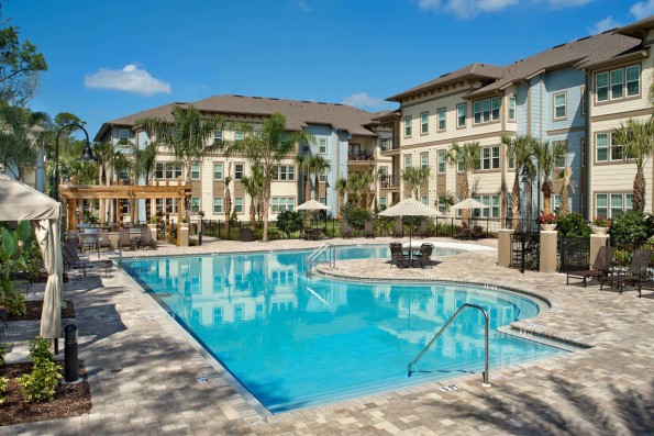 Tropical beach entry pool with cabanas and grill pavilion