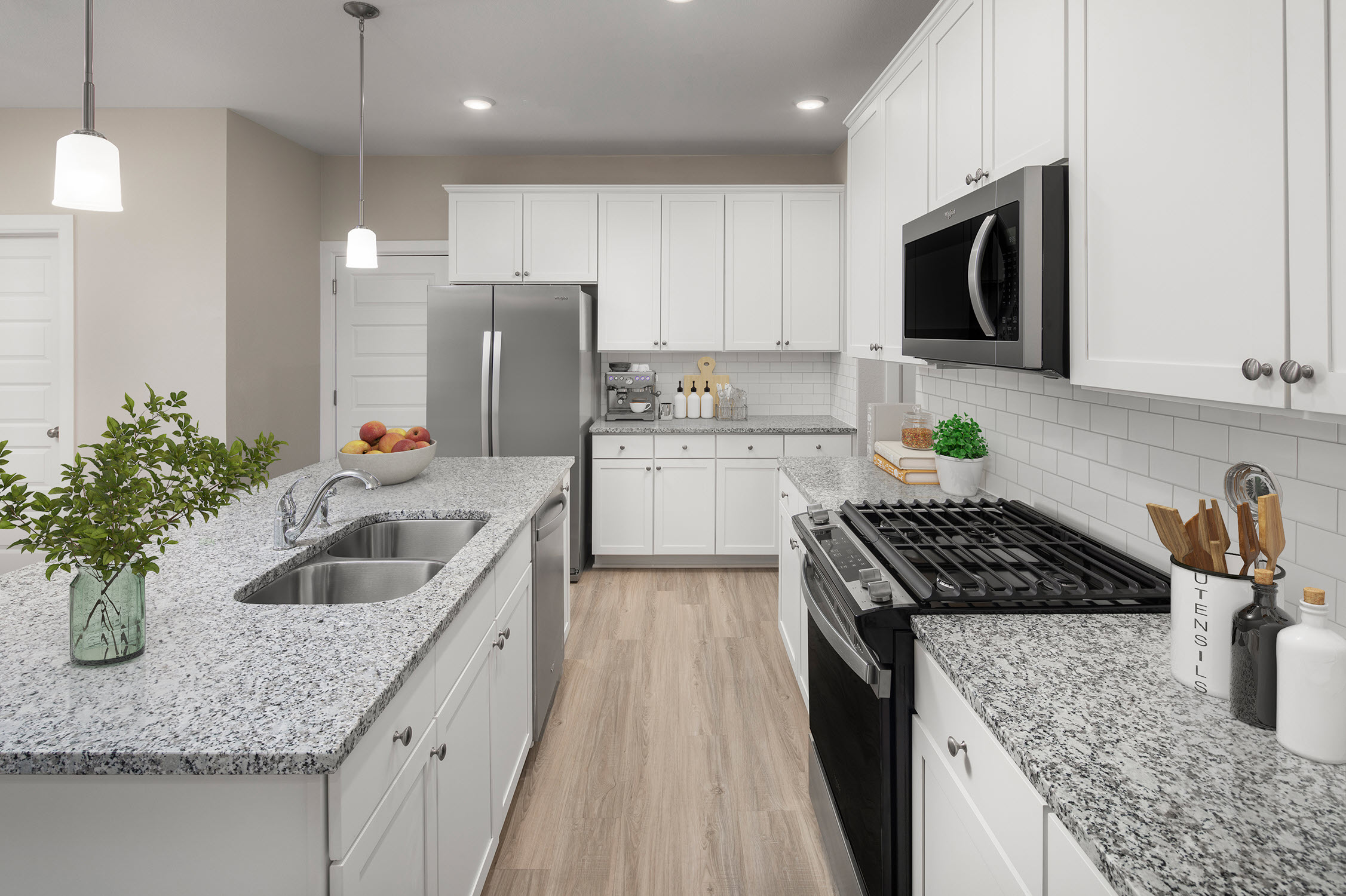 Kitchen with island and gas cooktop at Camden Woodmill Creek homes for rent in Spring, TX