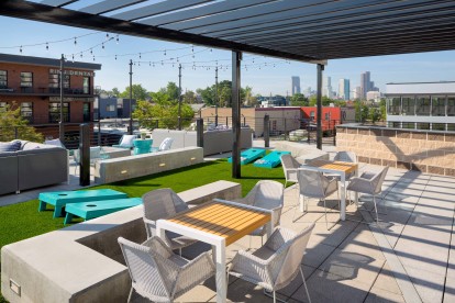 Rooftop Lounge with dining areas, corn hole, and city views