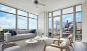 Living room with floor to ceiling windows and downtown views