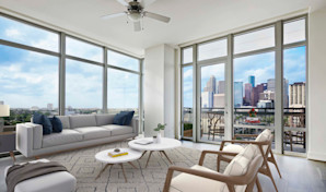 Living room with floor to ceiling windows and downtown views