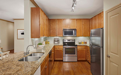 Kitchen with glass cooktop and granite countertops