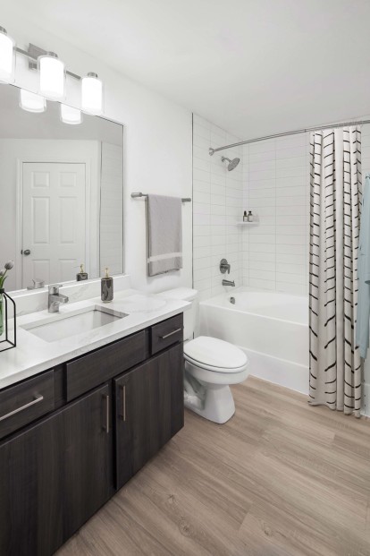 Bathroom with white quartz countertops and soaking tub at Camden Panther Creek apartments in Frisco, Tx