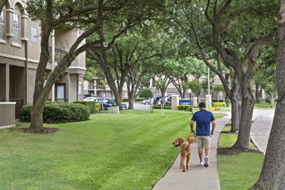 Resident walking their dog at the community