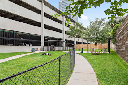 Onsite private dog park with seating at Camden Post Oak Apartments in Houston, TX