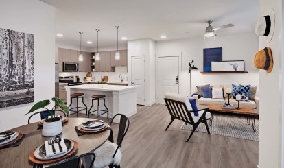 Contemporary style open-concept dining and living room with hardwood-style flooring