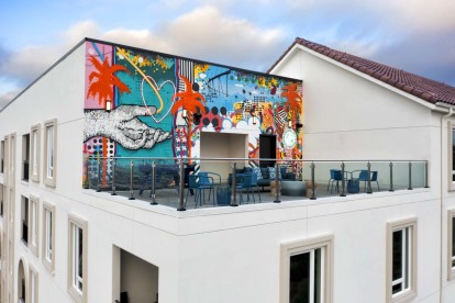 Camden Hillcrest Apartments San Diego CA Third floor terrace with seating and mural by Arte Gennaro Garcia