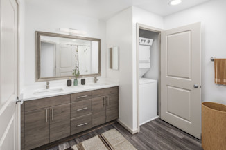 Bath with double-sink vanity and stackable washer and dryer at Camden Potomac Yard apartments in Arlington, VA