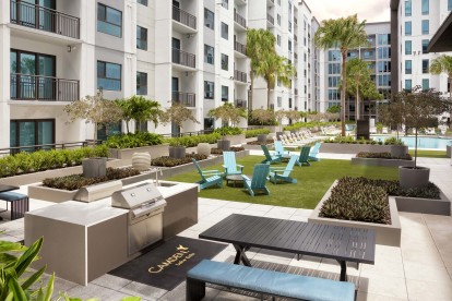 The amenity deck on the seventh floor includes poolside grills and seating areas at Camden Lake Eola apartments in Orlando, FL