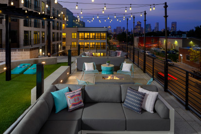 Rooftop Lounge with string lights, fire pits and yard games