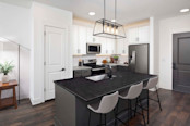 Kitchen with two-tone light and dark cabinets and wood-style flooring at Camden West Nashville apartments in Nashville, TN