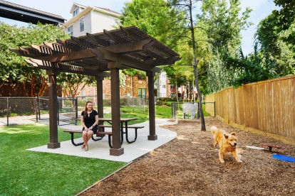Onsite dog park with seating and agility equipment at Camden Heights Apartments in Houston, TX