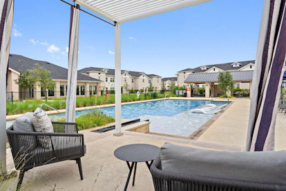 Poolside cabanas looking out toward pool at Camden Leander apartments in Leander, Tx