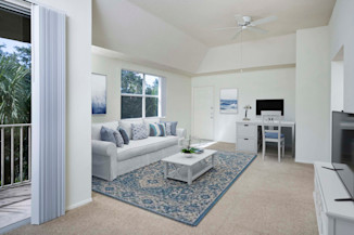 Apartment home living room with work from home space at Camden Plantation in Plantation, FL.