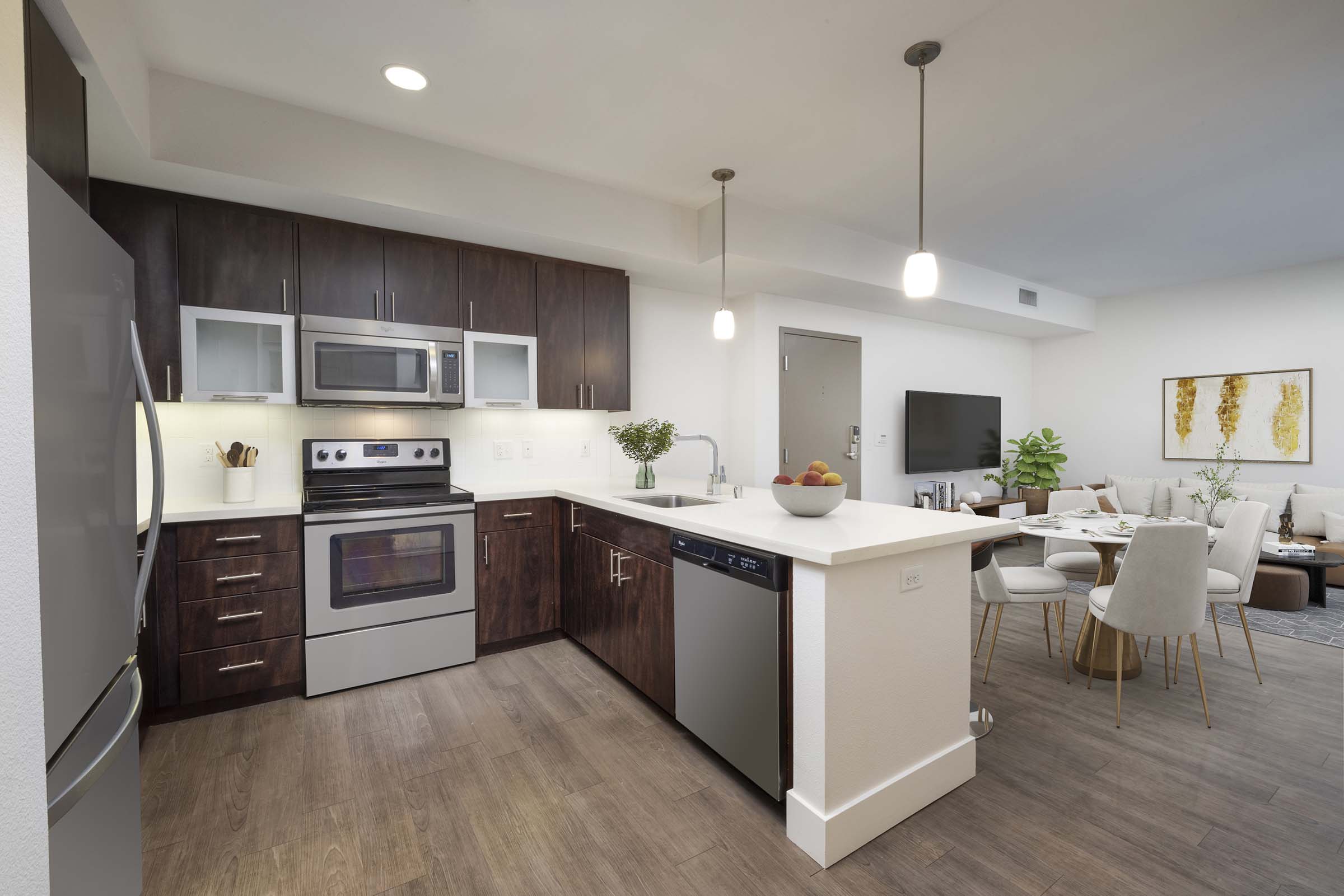 Open concept kitchen with stainless steel appliances and dining area