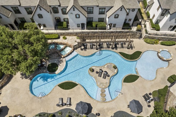 Aerial view of buildings overlooking resort-style pool at Camden Brushy Creek apartments in Austin, TX