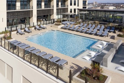 Swimming pool with lounge chairs and tanning deck