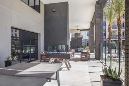 Camden Tempe West Apartments in Tempe Arizona outdoor resident lounge game area with ping pong and foosball tables 