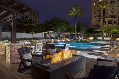 Poolside firepit and seating at night