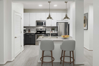 Kitchen with stainless steel appliances and quartz countertops at Camden Heights apartments in Houston, TX