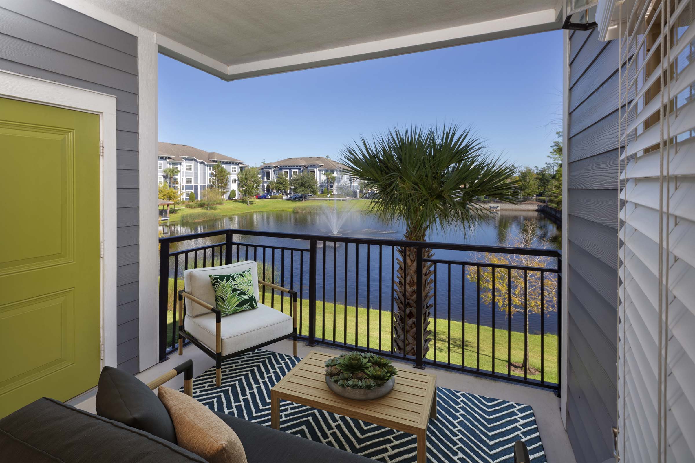 Balcony with storage and view of lake and water fountain