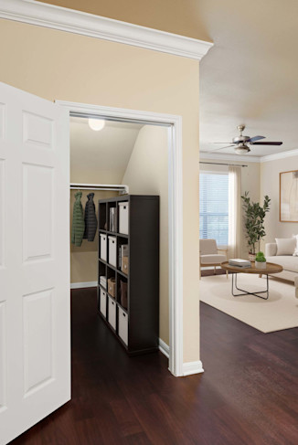 Living room with storage closet under the stairs and wood-style floor at Camden Brushy Creek apartments in Cedar Park, TX