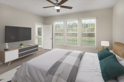 Bedroom with ceiling fan and private backyard at Camden Woodmill Creek homes for rent in Spring, TX