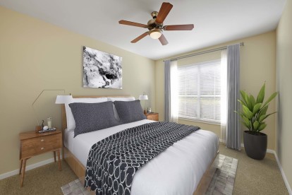 Bedroom with beige walls and ceiling fan