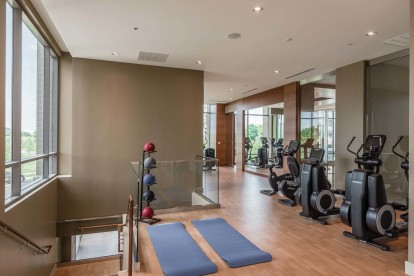 Two-story fitness center with cardio training and yoga equipment