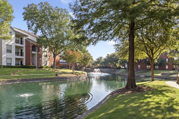 Tree-lined lake with fountains within Camden Buckingham