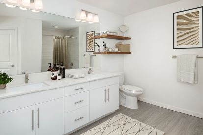 Lovely bathroom with double sink vanity and satin nickel finishes and Moen fixtures at Camden Lake Eola apartments in Orlando, FL.