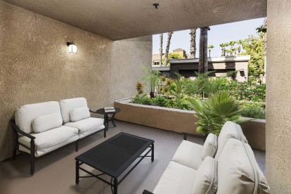 Patio with room for seating and landscaped grounds