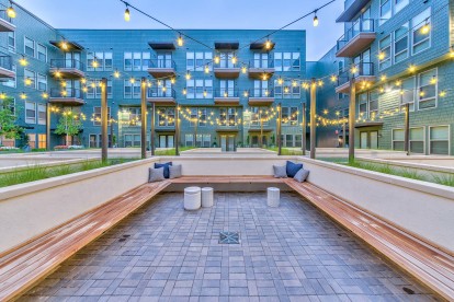 Courtyard seating at twilight with string lights overhead