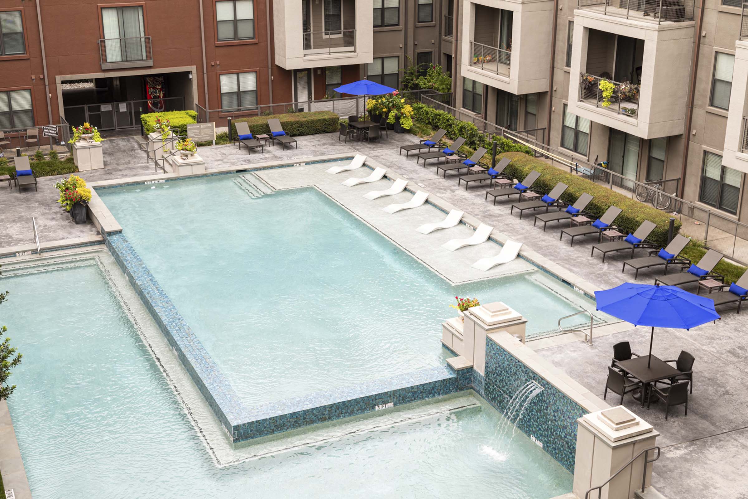 Resort style pool with lounge chairs and outdoor dining