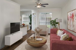 Living room with large windows and ceiling fan at Camden Lago Vista apartments in Orlando, FL