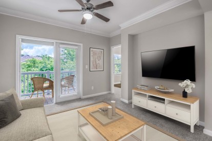 Camden Peachtree City apartments in Peachtree City, GA living room with ceiling fan and view of balcony