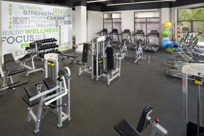 24-Hour Fitness Center with a wide array of cardio and strength training equipment