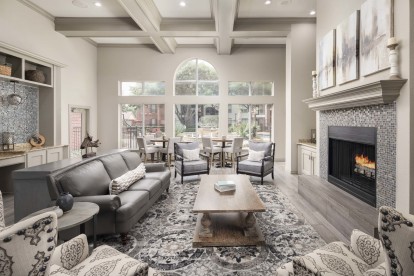 Clubhouse with fireplace and seating at Camden Buckingham apartments in Richardson, TX